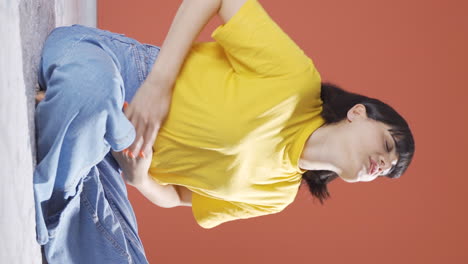 Vertical-video-of-Young-woman-with-stomachache.